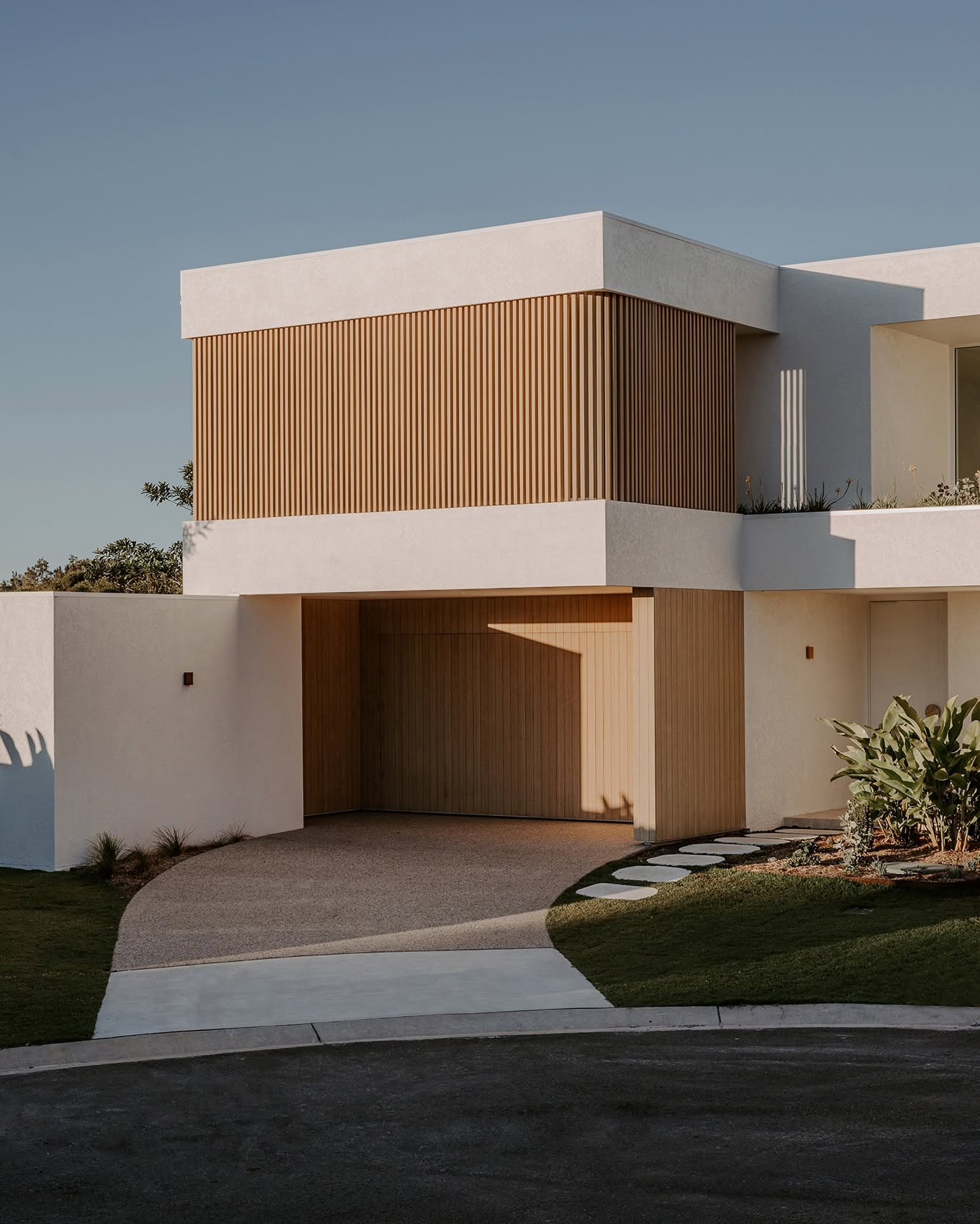 Timber battens and sculpted white masonry at Harvest Moon