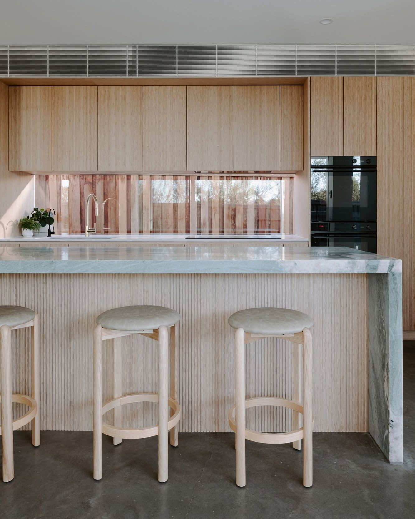 Bamboo cabinetry and a stone island at Harvest Moon, Byron Bay